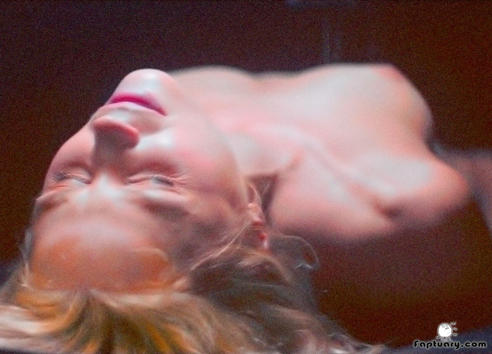 Jenna Harrison medical fetish scene where she's lying on a slab completely naked while being injected by a machine